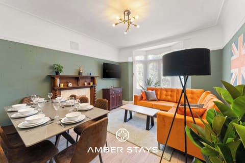 A stylish living room featuring a bold blend of green and violet tones, creating a vibrant and unique atmosphere. The space is designed to feel both modern and inviting—perfect for relaxing, socializing, or unwinding after a long day.