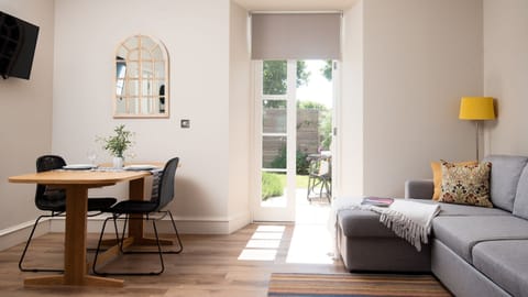 Cambridge House Cottage Number One - the open-plan dining and living area with a door to the garden