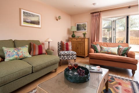 Wall Cottage - the living area with folding doors opening out to the garden