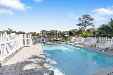 Dive into your private oasis! Crystal-clear pool waters await with waterfront views and tropical palms creating your perfect escape.