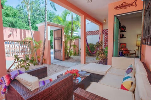 Unwind in this gorgeous, covered outdoor lounge. Featuring plush sectional seating, a relaxing hammock, and vibrant coral architecture, this intimate space is surrounded by lush tropical greenery, offering a truly secluded and delightful escape.