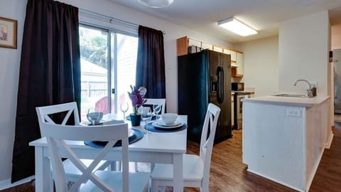 Dining area set for meals, with easy access to the kitchen for casual dining or takeout nights.