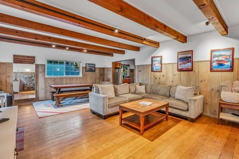 Living Room (main floor): L-shaped sectional, Smart TV, wood-burning fireplace