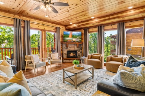 Living room featuring a fireplace and large TV, perfect for unwinding.