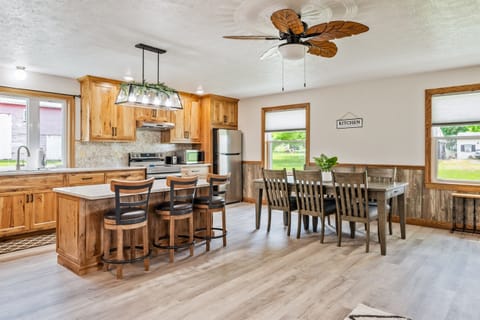 Enjoy meals with a view in this bright dining area featuring large windows, rustic wood accents, and cozy seating for six.