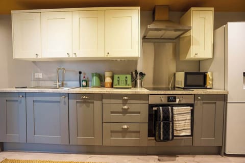 A full kitchen includes all the essential appliances and fixtures needed for cooking, preparing, and storing food.