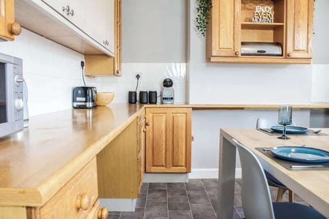 A spacious kitchen featuring polished surfaces, state-of-the-art appliances, and plenty of cabinetry for a seamless cooking experience.