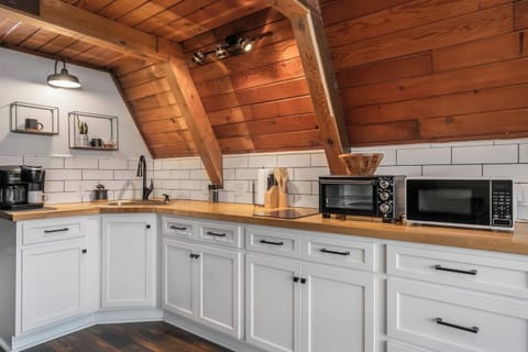 Kitchen with  sink, 2 burner range, refrigerator and freezer, microwave and toaster oven. 