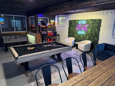 Game Room has a pool table, foosball, 4 arcade machines, photo wall and bar with 65” TV