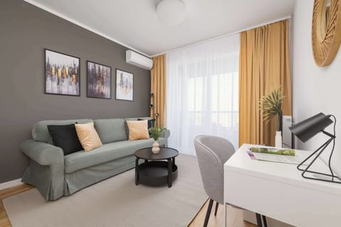 Comfortable living room with a desk for remote work during business trips.