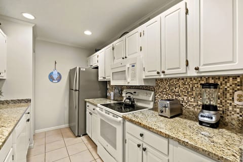 Whip up culinary delights in this modern kitchen with elegant granite counters