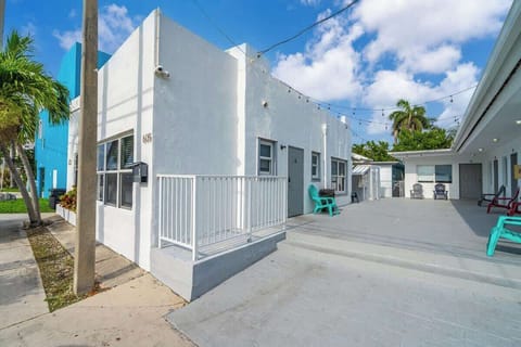 Relax under string lights in our vibrant outdoor lounge with palm trees and colorful seating. Great for evening chats and morning coffee.