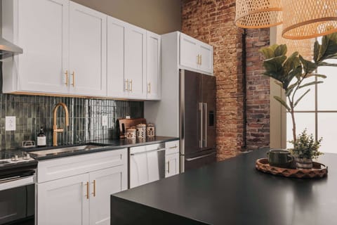 The modern kitchen is fully equipped with stainless steel appliances and thoughtfully stocked with everything you need to cook.