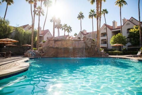 Soak up sunshine beside the soothing rock waterfall.