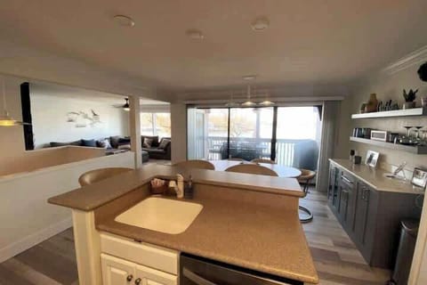 Open floor plan with wall-to-wall windows. View from the kitchen.