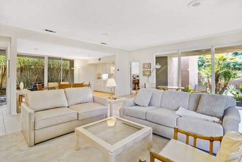 Bright and airy open-concept living room with seamless indoor-outdoor flow.