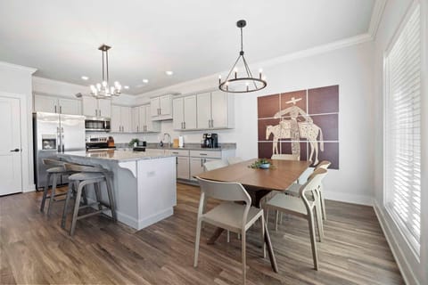 Whether you're preparing delicious meals in the fully equipped kitchen or enjoying take out at the dining table, the seamless flow of this space ensures everyone can be part of the fun.