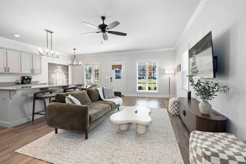 The living room features a large Smart TV with all your favorite streaming channels, along with plush seating.