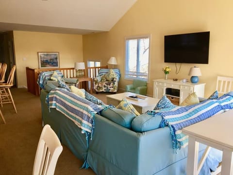 The cozy living room offers comfortable seating with a large sectional and entertainment setup, ideal for family movie nights.