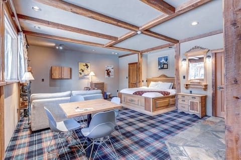 Open concept room with king bed, living room, fireplace and seating area.