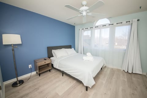 Bedroom with queen bed, closet, Smart TV and full bathroom.