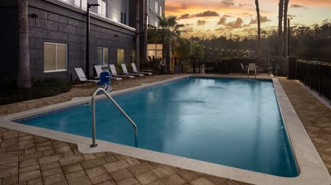 Savor golden-hour swims with tranquil sunset reflections on water.