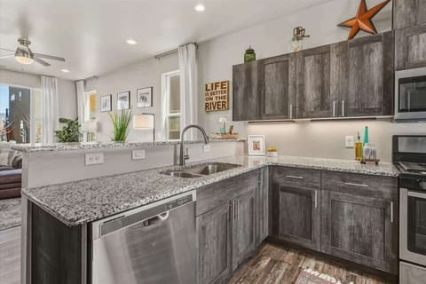 The fully equipped kitchen features modern appliances, including a coffee maker, microwave, gas range, oven, dishwasher, fridge, KitchenAid mixer, toaster, and blender—ideal for cooking and packing picnic lunches for a day of adventures!