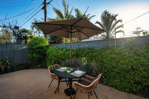 Cozy patio with dining for two, perfect for coffee or sunset dinners.