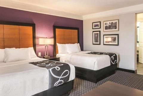 Unwind in crisp linens with cozy bedside lighting.