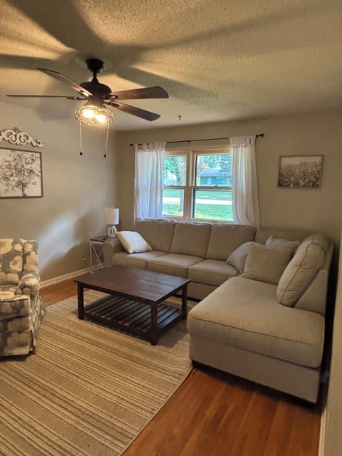 Living room with large screen tv on the wall 