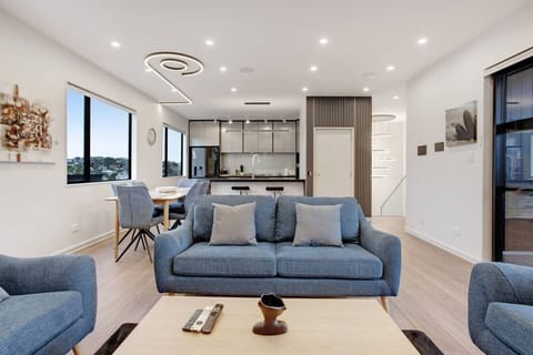 The open-plan living area has the kitchen, dining table and lounge area.