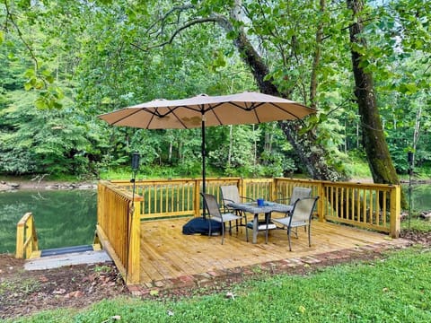 Custom built deck on river with steps leading down to dock.