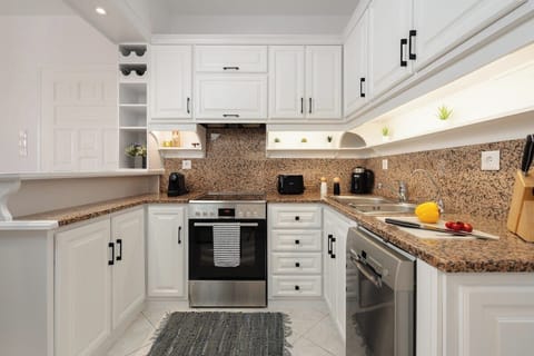 Kitchen fully equipped with a dishwasher, Nespresso and filtered coffee options, tea, kettle, microwave, toaster and drinkable filtered water.