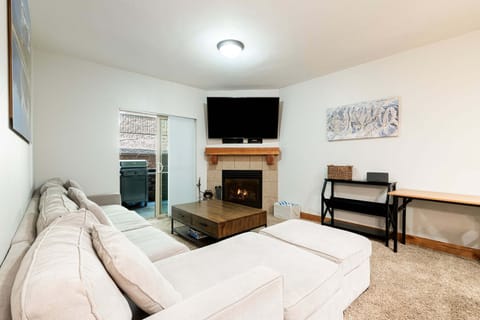 Living room with fireplace, smart TV and plenty of comfortable seating