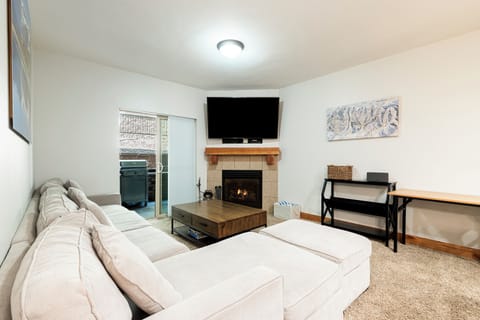 Living room with fireplace, smart TV and plenty of comfortable seating