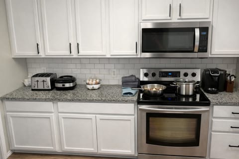 Fully Stocked Kitchen with Cookware and Appliances for Extended Corporate Stays