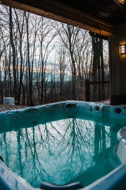 Unwind in the hot tub as the sun sets behind the trees