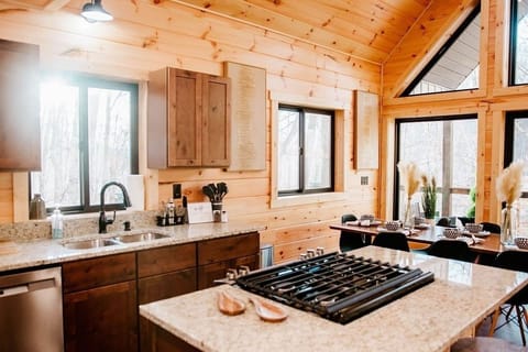 Stocked kitchen with granite counters and large windows