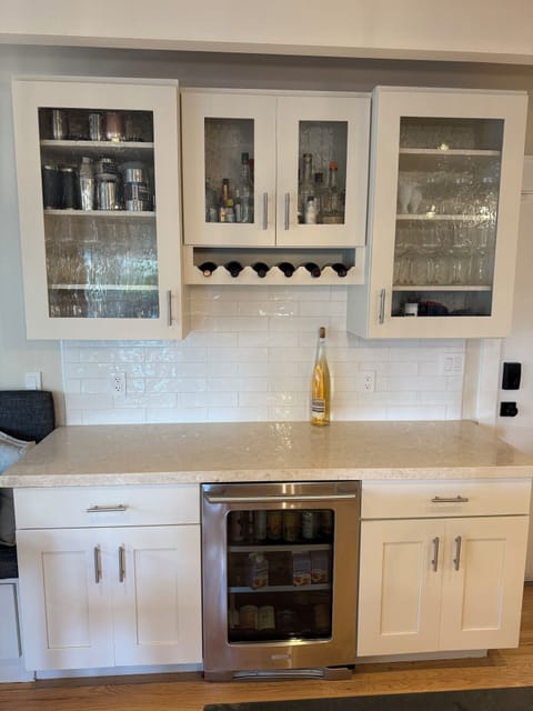 Bar area in kitchen with beverage fridge