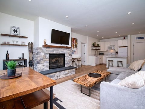 Living room with fireplace and open plan full kitchen