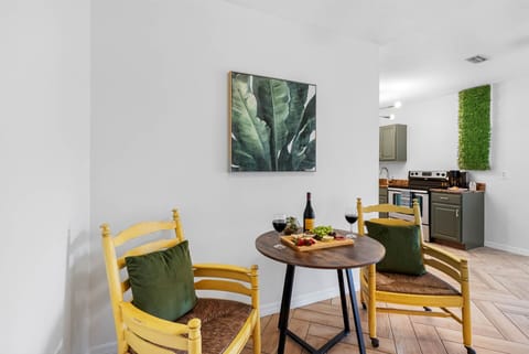 Rustic chairs with a vintage twist and vibrant green cushions create a cheerful, calming space to pause and reset.