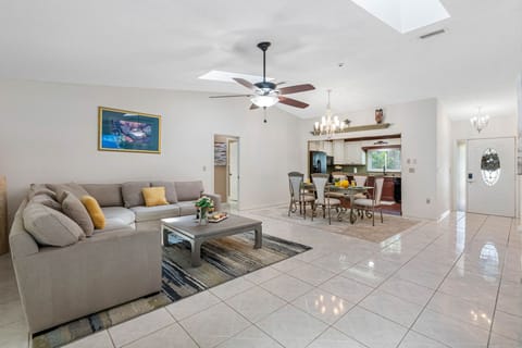 The ambiance is further elevated by the natural light that pours in through the oversized windows, making the room feel airy and bright throughout the day.