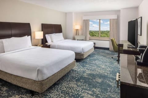 Unwind in bright double-queen comfort with peaceful views beyond.