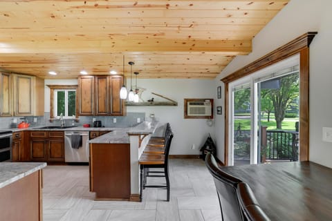 Guests Love the Farmhouse dining table table and raised snack bar on the island