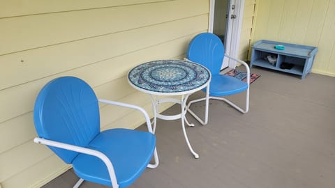 cozy table and chairs at front porch entry