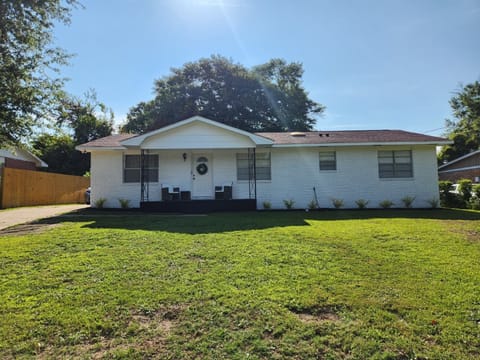 Charming front porch with seating and a spacious yard