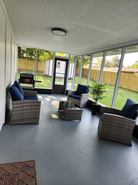 Screened porch with comfy seating and backyard access