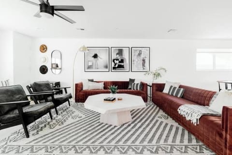 Living room has loads of seating and comes with a large 85" SmartTV.