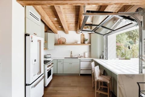 The kitchen offers high end Cafe appliances, cafe window and is fully stocked.