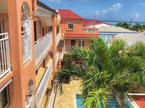Unwind by the breezy courtyard pool beneath swaying palms.